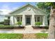 Charming single-story home with a welcoming front porch and neatly landscaped yard at 7013 Beargrass Rd, Harmony, FL 34773