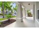 Inviting front porch with sturdy columns, offering a comfortable outdoor space at 7013 Beargrass Rd, Harmony, FL 34773