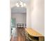 Hallway features wood flooring and a view into the open-concept living area at 7013 Beargrass Rd, Harmony, FL 34773