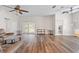 Open living room featuring wood-look flooring, modern furniture, and access to the patio at 7013 Beargrass Rd, Harmony, FL 34773