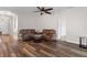 Comfortable living room featuring hardwood floors and neutral wall color scheme at 7013 Beargrass Rd, Harmony, FL 34773