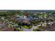 Aerial view of neighborhood, home and landscaping near a scenic pond at 803 Shady Canyon Way, Kissimmee, FL 34759