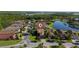 Aerial view of the neighborhood, home, landscaping, and nearby pond at 803 Shady Canyon Way, Kissimmee, FL 34759