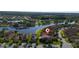 Aerial view of an idyllic neighborhood, highlighting lakeside houses, lush greenery, and neatly manicured lawns at 803 Shady Canyon Way, Kissimmee, FL 34759