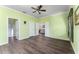 This large bedroom boasts hardwood floors, bright green walls, and multiple doors leading to other rooms at 803 Shady Canyon Way, Kissimmee, FL 34759