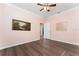 The bedroom features hardwood floors and a neutral color scheme with access to an adjacent room at 803 Shady Canyon Way, Kissimmee, FL 34759