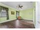 Spacious bedroom with hardwood flooring, green walls, a window with curtains, and crown molding at 803 Shady Canyon Way, Kissimmee, FL 34759