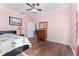 A cozy bedroom features hardwood floors, crown molding, and neutral-toned walls at 803 Shady Canyon Way, Kissimmee, FL 34759