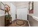 An elegant foyer with hardwood floors, neutral walls, decorative mirror, and useful coat storage at 803 Shady Canyon Way, Kissimmee, FL 34759