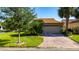 A well-maintained home with a two-car garage and a brick paved driveway at 803 Shady Canyon Way, Kissimmee, FL 34759