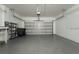 Spacious two-car garage with epoxy floor, peg board, and ample storage space at 803 Shady Canyon Way, Kissimmee, FL 34759