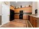 Spacious kitchen featuring wooden cabinets, black appliances, and ample counter space for meal preparation at 803 Shady Canyon Way, Kissimmee, FL 34759