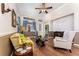 Cozy living room features hardwood floors, two-tone walls, and lots of natural light from a large window at 803 Shady Canyon Way, Kissimmee, FL 34759