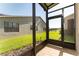 Screened-in patio offering views of the home, backyard, and nearby pond at 803 Shady Canyon Way, Kissimmee, FL 34759
