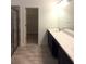 Modern bathroom with double vanity, white countertops, and tile flooring at 8607 Crescendo Ave, Windermere, FL 34786