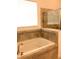 Elegant bathroom featuring a soaking tub with decorative tile accents at 8607 Crescendo Ave, Windermere, FL 34786