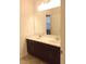 Bathroom with dual sinks, dark cabinetry, and large mirror at 8607 Crescendo Ave, Windermere, FL 34786