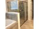 Bathroom featuring a tiled shower with glass door, and decorative tile accents at 8607 Crescendo Ave, Windermere, FL 34786