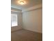 Bedroom with a tray ceiling, neutral walls, and a large window at 8607 Crescendo Ave, Windermere, FL 34786