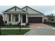 Inviting single-story home with a two car garage, brick paver driveway, and well-maintained landscaping at 8607 Crescendo Ave, Windermere, FL 34786