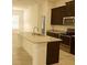 Modern kitchen with granite countertops, stainless steel appliances, and dark cabinetry at 8607 Crescendo Ave, Windermere, FL 34786
