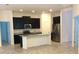Contemporary kitchen with an island, dark cabinets, and stainless steel appliances at 8607 Crescendo Ave, Windermere, FL 34786