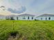 View of the expansive backyard featuring lush green grass at 1190 Lexington Lane, Haines City, FL 33844
