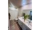Bathroom with a double sink vanity, tile floors and a shower with curtain rod at 1190 Lexington Lane, Haines City, FL 33844