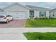 Charming one-story home with a well-maintained front yard and brick paver driveway at 1190 Lexington Lane, Haines City, FL 33844