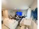 Spacious living room featuring white sofas, a fireplace, and a large TV at 1190 Lexington Lane, Haines City, FL 33844