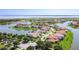 Aerial view of a lakeside residential community with mature trees and manicured landscaping at 1211 Terralago Way, Kissimmee, FL 34746