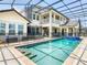A large pool and spa highlight the large backyard with view of the home's back elevation at 1211 Terralago Way, Kissimmee, FL 34746