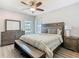 This spacious bedroom features nice trim work, hardwood floors, and an amazing bed at 1211 Terralago Way, Kissimmee, FL 34746