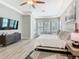 This spacious bedroom features nice trim work, hardwood floors, and a decorative ceiling fan at 1211 Terralago Way, Kissimmee, FL 34746