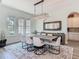 Bright dining room with a modern chandelier, large mirror, and windows overlooking the landscaped yard at 1211 Terralago Way, Kissimmee, FL 34746