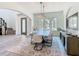 Dining room with a modern chandelier, light walls, large windows, and seating for six at 1211 Terralago Way, Kissimmee, FL 34746