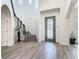Stunning foyer with a decorative glass front door, staircase, and elegant light fixtures at 1211 Terralago Way, Kissimmee, FL 34746