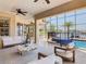 Expansive lanai with travertine floors, jacuzzi, and views of the pool and lake at 1211 Terralago Way, Kissimmee, FL 34746