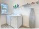 The laundry room has a window, washer, dryer, and ironing board at 1211 Terralago Way, Kissimmee, FL 34746