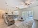 A bright and airy living room featuring sliding glass doors to the patio and a neutral color palette for a modern aesthetic at 1211 Terralago Way, Kissimmee, FL 34746