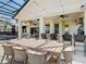 Outdoor dining area with stone countertop, ceiling fans, string lights and ample seating at 1211 Terralago Way, Kissimmee, FL 34746