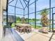 Covered outdoor dining area with seating for six offering views of the surrounding landscape at 1211 Terralago Way, Kissimmee, FL 34746