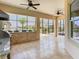 Spacious screened lanai with outdoor kitchen and dining area overlooking the water at 1211 Terralago Way, Kissimmee, FL 34746