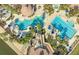 Aerial view of resort-style community pools with palm trees, cabanas, and lounge chairs at 1211 Terralago Way, Kissimmee, FL 34746
