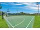 Outdoor basketball court featuring green surface, white lines, hoops, and court side seating at 1211 Terralago Way, Kissimmee, FL 34746