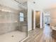Modern bathroom featuring a glass-enclosed shower with a seat and stylish tile work at 1211 Terralago Way, Kissimmee, FL 34746