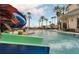 Resort-style pool with slide, palm trees, and lounge chairs for relaxing at 1211 Terralago Way, Kissimmee, FL 34746