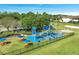 Community playground with a colorful play structure, picnic tables, and lush green surroundings at 1211 Terralago Way, Kissimmee, FL 34746
