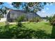 A spacious backyard features a large screened-in lanai and lush green grass at 12649 Dallington Ter, Winter Garden, FL 34787