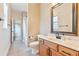 Well-lit bathroom with modern vanity, framed mirror, and tiled floors at 12649 Dallington Ter, Winter Garden, FL 34787